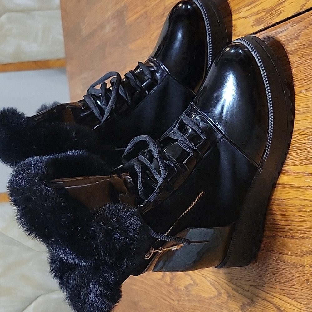 A nice pair of women's stylish boots black and suede patent leather boots.
